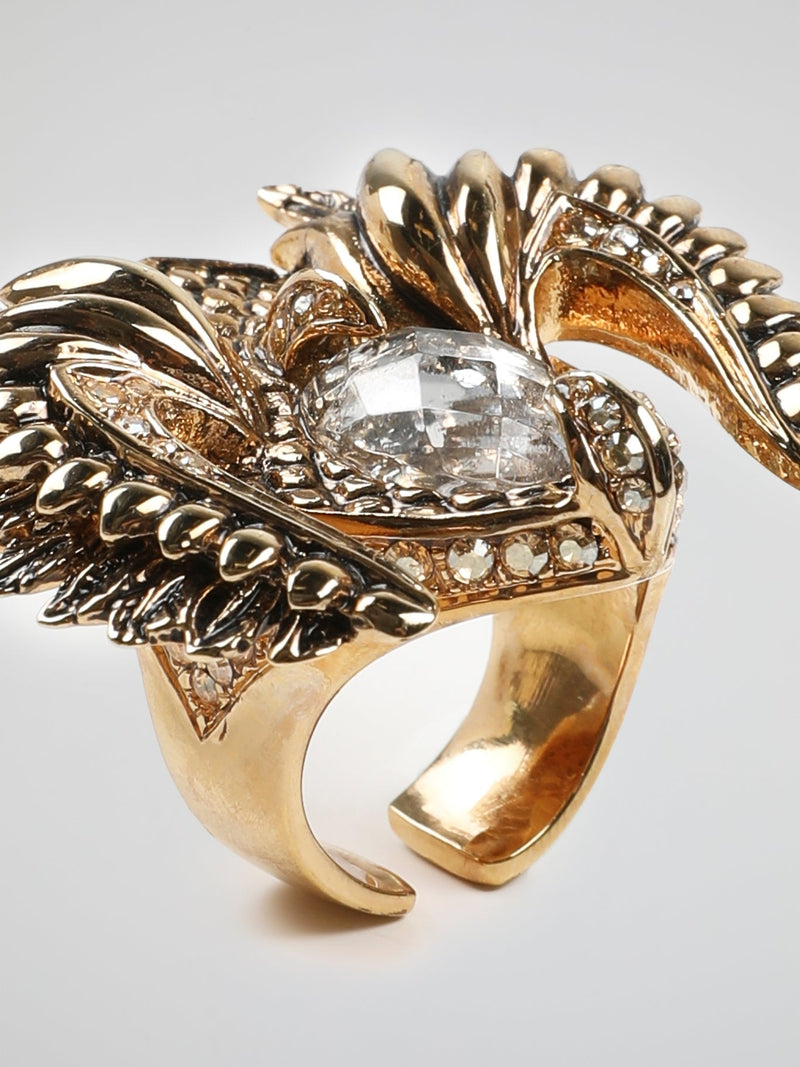 Introducing the Gold Crystal Bird Ring by Roberto Cavalli - an exquisite masterpiece that captures the essence of elegance and grace. Crafted with meticulous attention to detail, this stunning ring features a delicate bird motif adorned with shimmering crystals in a captivating gold setting. Let your style take flight with this exquisite accessory that combines nature's beauty with Roberto Cavalli's signature opulence.